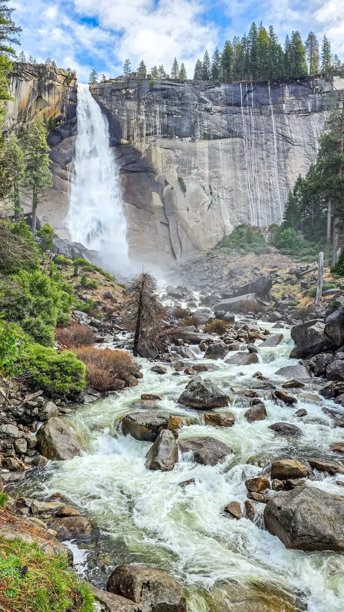 Nevada Fall waterfall on Mist Trail with Merced River flowing over granite cliffs and boulder field below