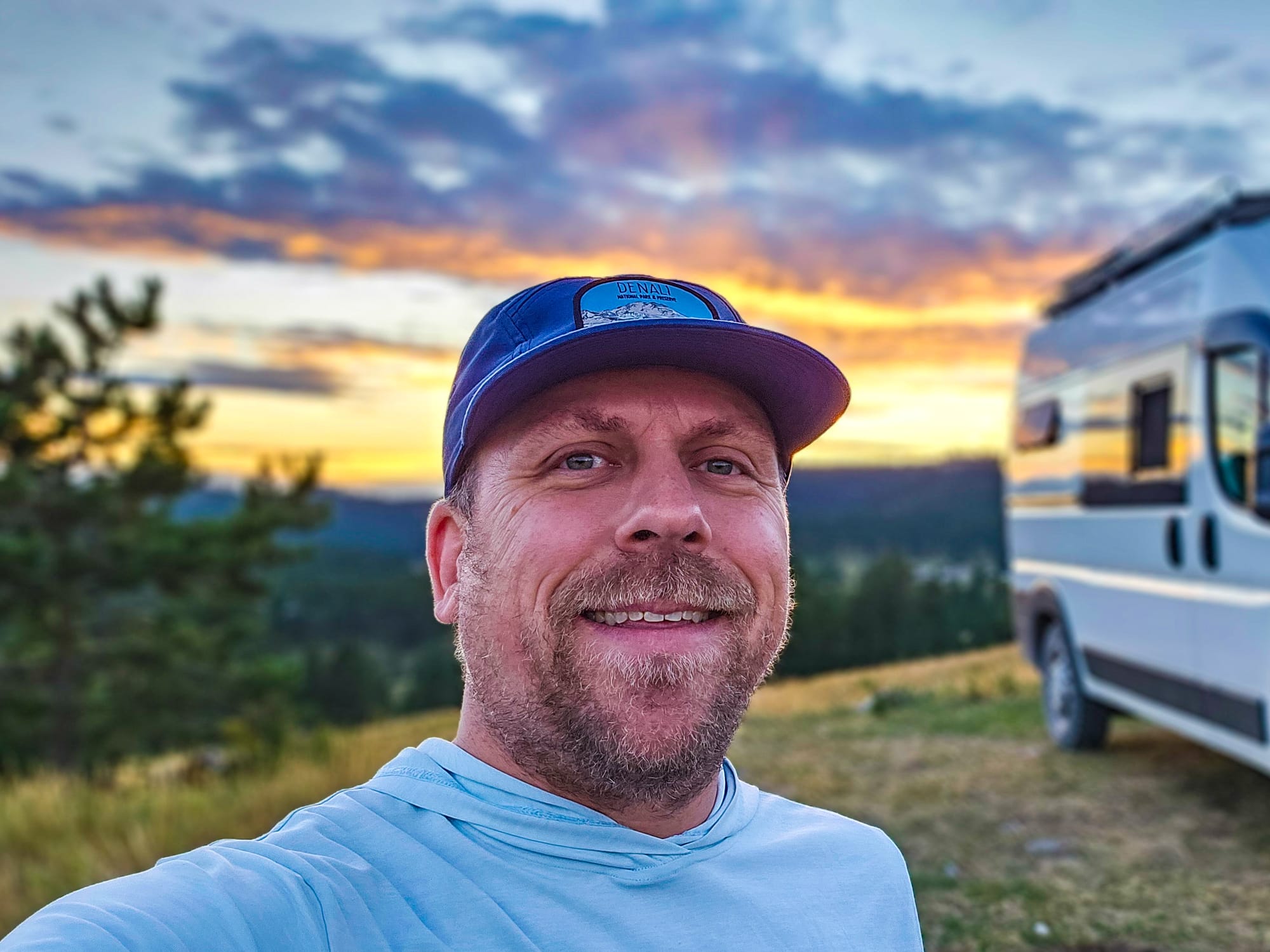 Yosemite Guide Eric Kufrin in the mountains next to his van "Sierra" at sunset