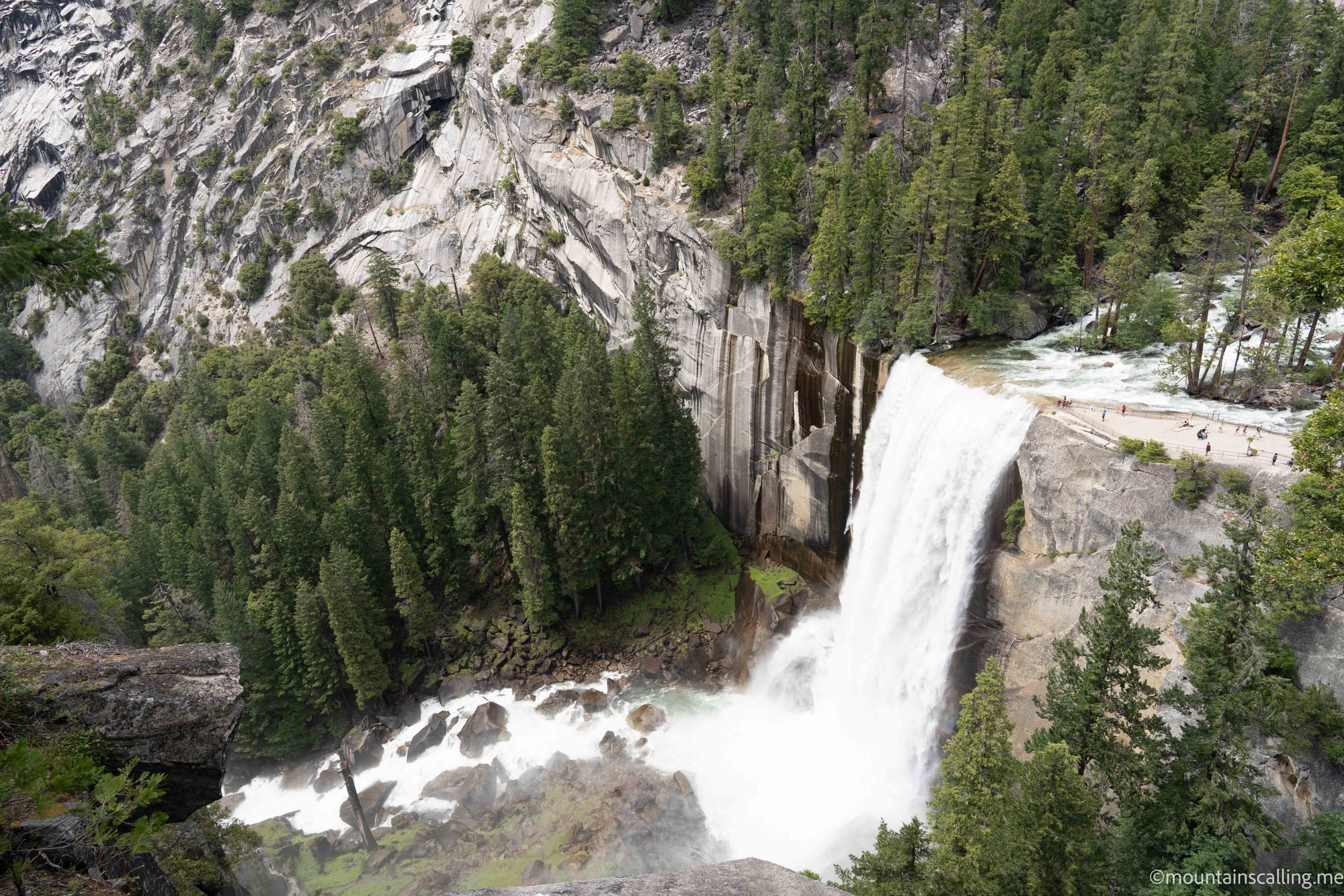 Vernal Fall seen from above on the John Muir Trail near Clark Point in Yosemite with hikers visible at the base for scale | Yosemite Life | Yosemite.Life