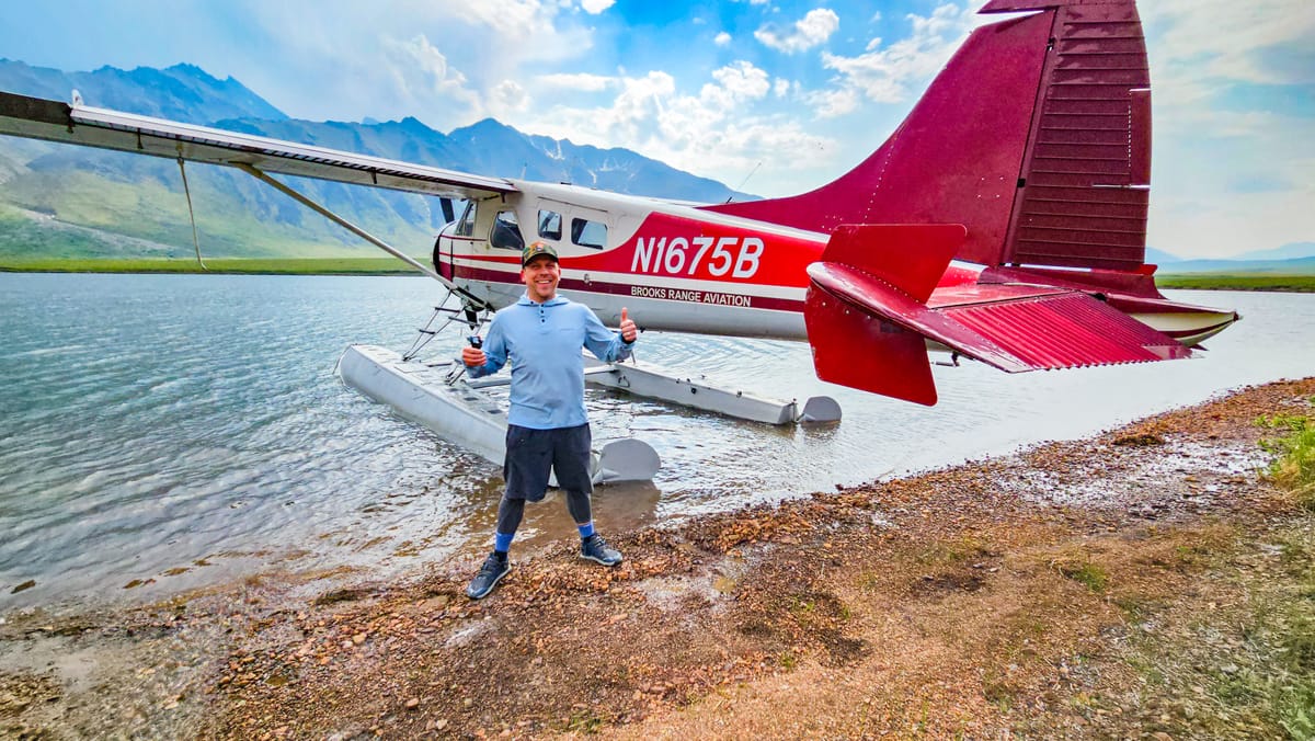 Eric Kufrin professional Yosemite Guide standing in front of an 1950s float plane in Gates of the Arctic National Park